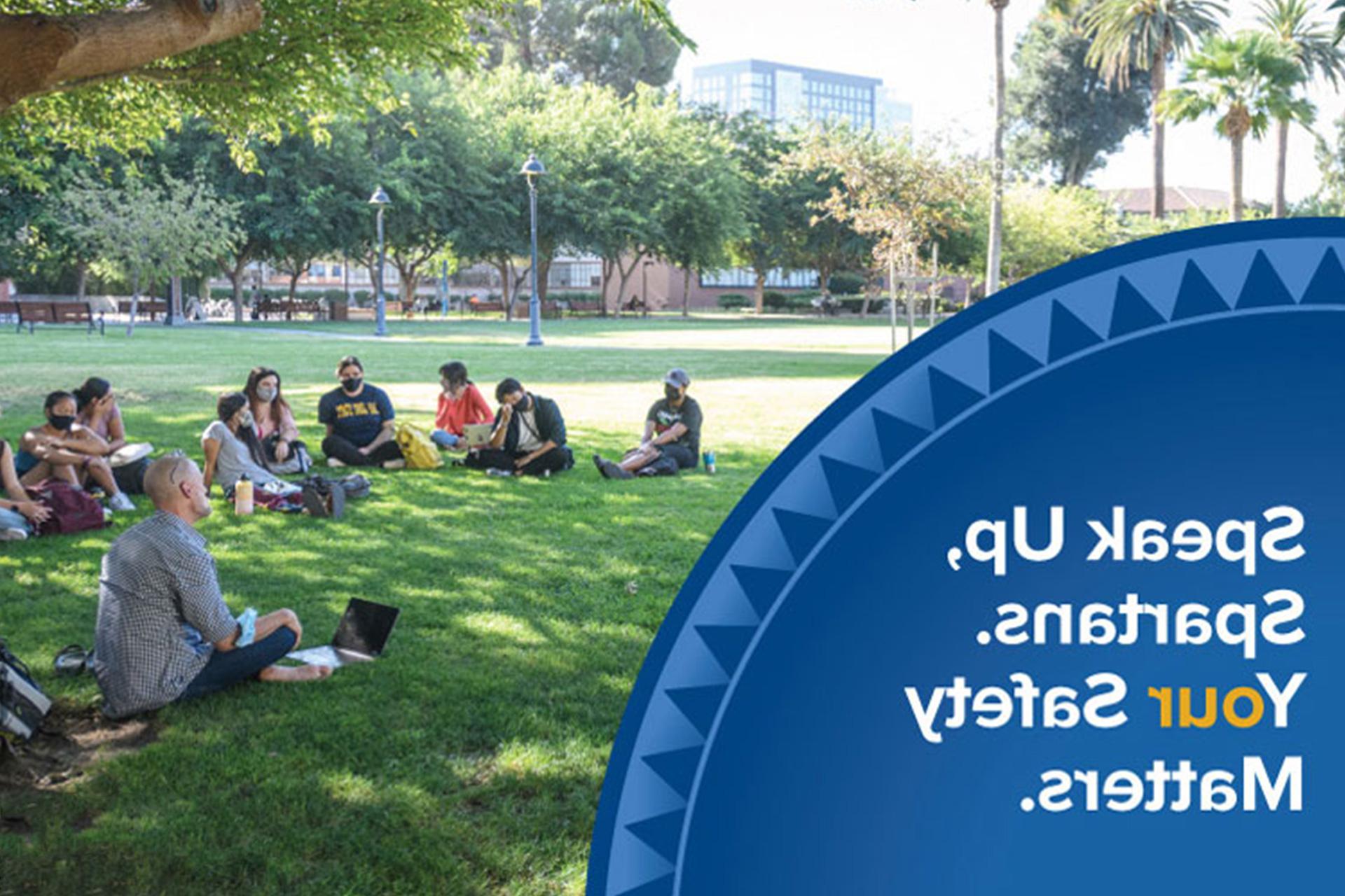 Students sitting in a circle formation on the campus lawn. A shield apprears on the corner with the words Speak Up, Spartans. Your Safety Matters.